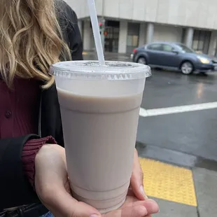 a woman holding a drink