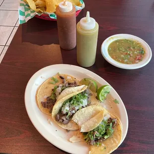 two plates of tacos and a drink