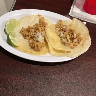 two tacoss on a plate