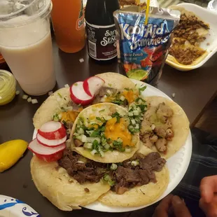 a plate of tacos and a drink