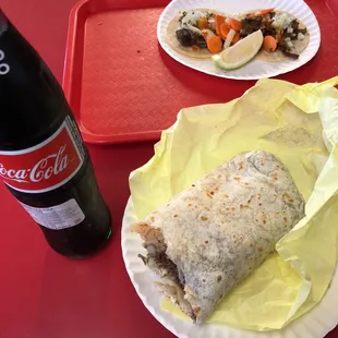 a plate of food and a bottle of coke