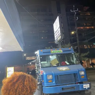 a blue truck parked in a parking lot