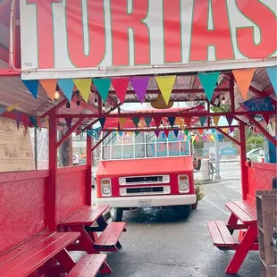 a taco truck parked under a tent