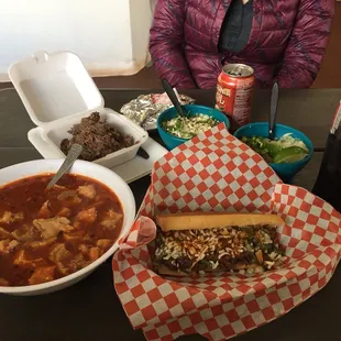 a woman sitting at a table with food