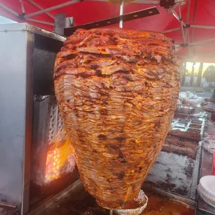 a kebab being cooked on a grill