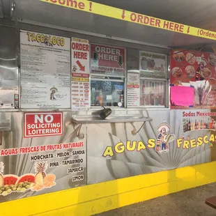 a taco stand with menus