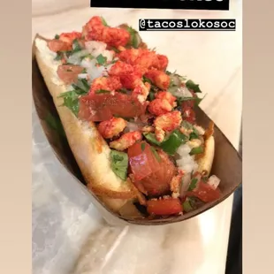 Bacon wrapped hot dog with bell peppers, onions, cilantro and hot cheetos!