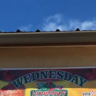 a sign for wednesday's special tacos al pastor buy one get one free