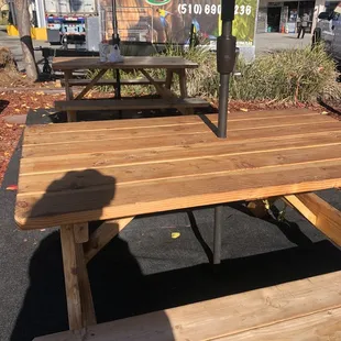 2 bench tables behind food trailer