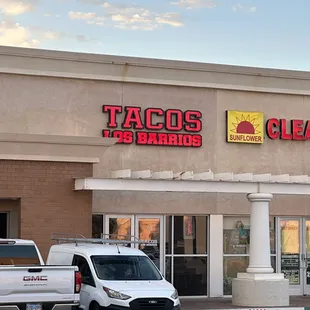 two trucks parked in front of a taco's restaurant