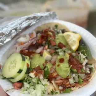 a person holding a plate of food