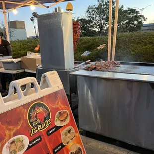 a taco stand with a menu