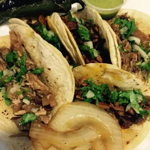 Tacos, grilled jalapeño, grilled onions, and avocado salsa. So freaking good! Try the carnitas! ;)