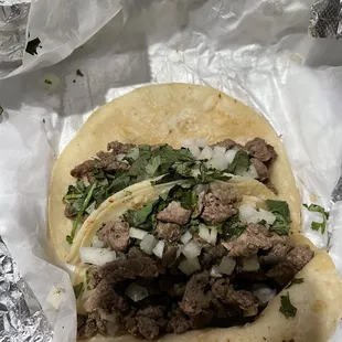 a taco with meat and onions