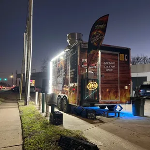 a taco truck parked on the side of the road