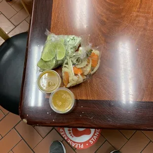 Sauces and limes and cilantro with pickled onions and carrots