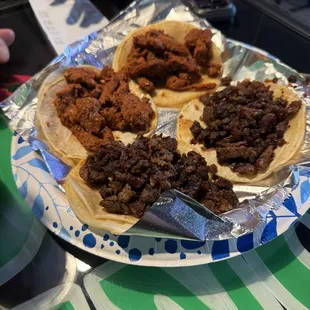 Tacos, pastor and asada. Toppings are available at their cold bar.