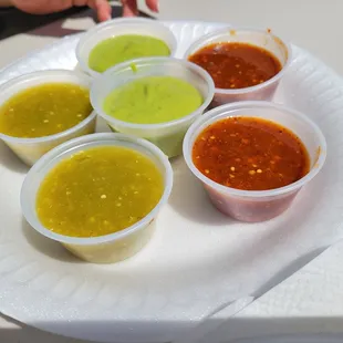 a variety of condiments on a paper plate