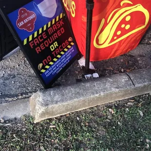 a trash can and a sign