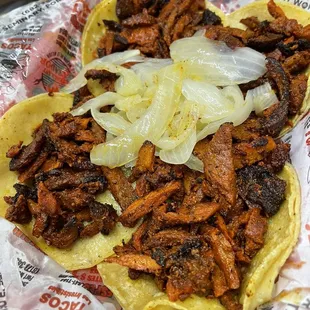 Al pastor trompos taco. They have a salsa bar with cilantro, onions, pickled jalapeños and salsa.