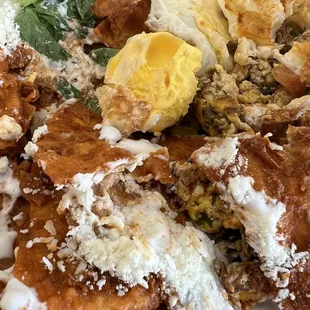 Chilaquiles with over hard eggs and machaca with scrambled eggs, beans and rice