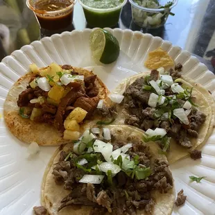 Salsas, lime, and onions/cilantro added to tacos