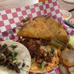 Asada taco, chorizo taco, quesabirria taco, and roasted serrano &amp; onions.