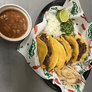 a plate of tacos and a bowl of salsa