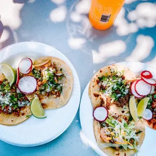 two plates of tacos on a table