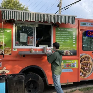 a man ordering food from a food truck