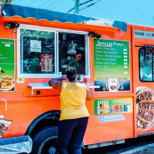 a woman ordering food from a food truck