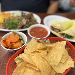Chips, Salsa, and Spicy Pickled Carrots served when dining in.