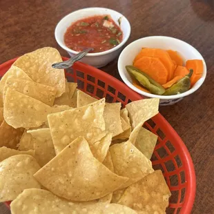 Chips, salsa, and pickled carrots served when dining in