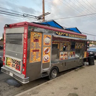 a taco truck parked on the side of the road