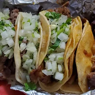 3 asad tacos on left with 3 pastor one with no onion and cilantro