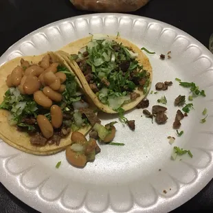 two tacos on a paper plate