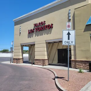 the entrance to a tacos lot