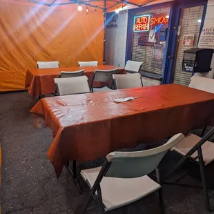 tables and chairs under a tent