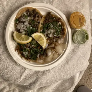 Birria tacos, Al pastor, and suadero tacos. The green sauce is so good. Orange, tamarind flavored sauce was super spicy
