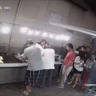 a group of people in a kitchen