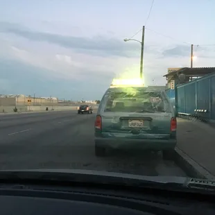 the back of a car driving down a street