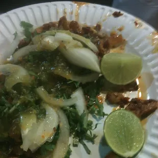 Tacos al pastor with green salsa.