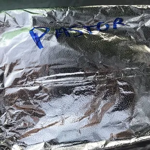 a taco wrapped in aluminum foil
