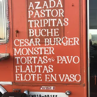 a food truck with a menu written on it