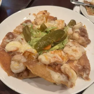 Shrimp Nachos. So good! Comes with cheese, beans, lettuce, guac. Shrimp is so juicy and fresh.