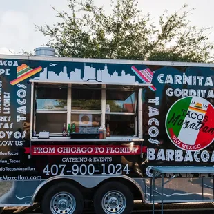 a taco truck parked on the side of the road