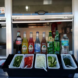 a variety of tacos in containers