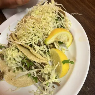 Asada tacos with cabbage onion cilantro and amazing salsa.