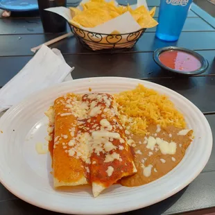Lunch combo #6 features a chicken enchilada,  a beef burrito,, beans, and rice.