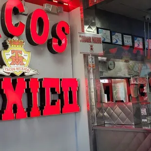 a mexican restaurant with neon signs